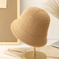 Minimalist beige knitted bucket hat for women in warm thick yarn on a metal display stand - M (56-58cm) / Khaki