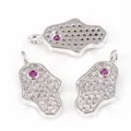 Silver Hamsa pendant with white cubic zirconia and a pink center gemstone charm - White Gold Plated