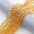 Macro shot of 8mm yellow amber AB rainbow plated glass beads on a display roll - 8mm (Approx. 100pcs) / Golden Plum Red