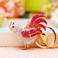 Sparkling rooster keychain with white and pink crystals on a golden metal alloy frame - Hen