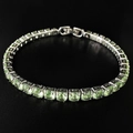 Close-up of silver tennis bracelet with round mint green stones on a black reflective surface - 5mm-19cm / Light Green Zirconia