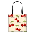 Foldable canvas shopping bag with red cherry print and black handles on cream background - Beige Cherry Print