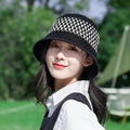 Outdoor shot of a black and white hollow crochet bucket hat with breathable knit pattern - Middle Stripe Black