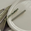 Detail view of marble green and matte grey acetate hair clips on a ceramic plate - Green Long 2pcs Set