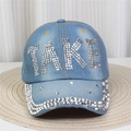 Gros plan du mot TAKE en strass argentés sur une casquette en denim bleu clair - No.15-Lettre TAKE-Bleu