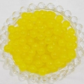 Macro view of translucent yellow glass beads in a clear tray for DIY jewelry making - 4mm / Lemon Yellow