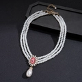 Close-up of triple-layer baroque pearl necklace with a pink oval stone flower pendant - Pink Main Stone Multi-layer Pearl Necklace