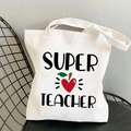 White canvas tote bag featuring Super Teacher text and red heart apple print - Super Teacher Heart Apple