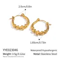Macro detail of 18K gold plated stainless steel star hoop earrings on white background - Gold Star Style (YYE023046)