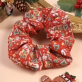 Detail showing a red Christmas themed scrunchie with Santa and tree prints in a gift set - Christmas Style 3 (Red Santa Claus)