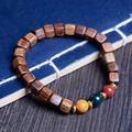 Detail of sandalwood bead bracelet featuring dark square beads and colorful spacer rings - 7mm Three Colors Sugar Cube / Black Rosewood Color