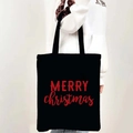 Black canvas Christmas tote bag with red Merry Christmas print shown on model shoulder - Style 11-Red Art Letter Christmas