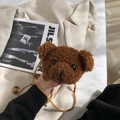 Cute teddy plush bear shaped crossbody bag with brown woven strap on a beige jacket - Brown