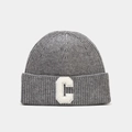 Detail view of grey knit beanie featuring a white letter C patch with soft texture - Gray