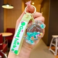 Close-up of mint green candy-shaped keychain with colorful floral filler and metal ring - Lollipop String [green] Glow-in-the-dark Bubble Bead Candy