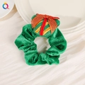 Detail of green velvet Christmas scrunchie with gift box ornament on white plate - Christmas Cartoon Scrunchie - Gift Box