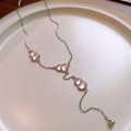 Macro detail of Y-shaped silver necklace with three pink gourd charms in ceramic bowl - Silver Pink Gourd Y-Necklace Style (15#)