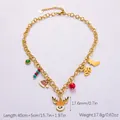 Golden Christmas necklace with reindeer, Santa hat and bell charms on white background - Reindeer Multi-pendant Necklace (XL31177)