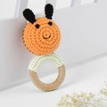 Detailed macro shot of handmade crochet bee rattle with natural wooden teething ring - Bee Rattle