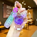 Detail of Mickey-shaped keychain with purple sequins and a gradient Bubble wrist strap - Purple Sitting Bear with Gradient Rope