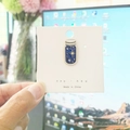 Detail of star pattern enamel pin in a bottle shape with white display backing card - 19*Starry Night Bottle Pin