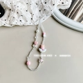 Detailed shot of handmade beaded phone strap with pink tulip and white bow charms - Pink Tulip