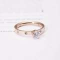 Détail macro d'une bague en or rose avec serti à six griffes et petits diamants ronds - US 5 / Or rose
