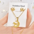 Macro detail of a gold stainless steel necklace and dragonfly earrings set on card - Gold Moon Dragonfly