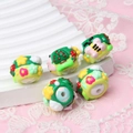 Close-up of hand-painted acrylic beads with mushroom and flower motifs for DIY crafts - Butterfly and Flower