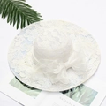 Elegant white lace sun hat with a large organza bow and intricate floral hollow texture - Floral White