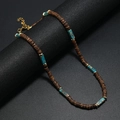 Detail of ethnic beaded necklace with brown coconut discs and turquoise stones - Mint Blue