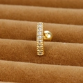 Detailed close-up of golden zircon bar stud earring with screw back on velvet - 65040-3 Equal Round Zirconia Line / Gold