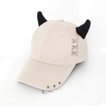 Detail of beige baseball cap featuring black devil horns and silver metal rings - Cross Stitch Beige