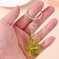 Translucent lime green pacifier keychain featuring a multi-faceted acrylic pendant design - Green Pacifier
