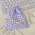 Close-up of purple gingham drawstring pouch with pink bow prints on a desk setup - Purple Gingham Bow (Small)