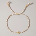 Handmade woven bracelet in white and gold featuring a metallic cross charm and adjustable cord - White Gold Tricolor Cross