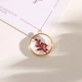 Golden round resin pendant featuring red dried flower and subtle glitter accents - Style 12
