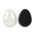 Portable egg-shaped detangling hairbrushes in pearlescent white and glitter pink finishes - Pearlescent White Holographic