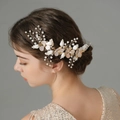 Elegant gold bridal hair comb with white pearls and flowers worn on a side bun - 4# Gold Hair Vine