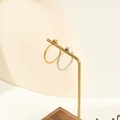 Detail of gold and silver textured hoop earrings on a metal jewelry display stand - 20mm / Steel