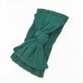 Soft dark green cable knit baby headband featuring a large textured bow design - Dark Green