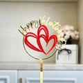 Close-up of golden acrylic Happy Valentine's Day cake topper with red double hearts decor - Red Gold Double Layer Heart