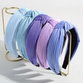 Knotted ribbed knit headbands in light blue, teal, purple and grey on a gold rack - Blue Purple Series
