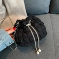 Black bucket bag with pleated fabric, silver metal chain, and white pearl drawstring details - Black