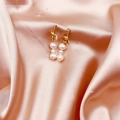 Elegant gold knot earrings with three baroque pearls on a soft champagne silk backdrop - Gold Knot White 3-Pearl Style