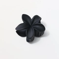 Macro shot of 8cm matte black plumeria flower claw clip with smooth resin finish - Matte Black
