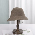 Classic straw bucket hat in dark beige on a vintage wooden stand for sun protection - M (56-58cm) / Olive Green