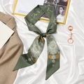 Green silk ribbon scarf with zodiac sun and star patterns tied as a hair accessory - Champagne Green Sun God