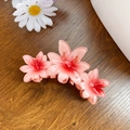 Pink gradient frangipani flower hair claw clip for women on a wooden background - Orange Red 11CM