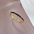 Macro view of gold plated stainless steel bracelet with black enamel inlay details - Minimalist Enamel Style / Gold/Black